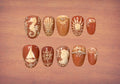 Ten press-on nails with marine themed terracotta and stucco wall frescoes reminiscent of Italian villas on the Mediterranean coast, in rich sienna and warm ivory tones. 