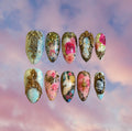 Luxury press-on nail set with Rococo style vintage floral and cupid designs on pink and blue background.