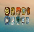Hand-painted fantasy press-on nails inspired by The Chronicles of Narnia featuring Aslan, the White Witch, Cair Paravel, the lamppost, and ornate gold and silver details.