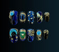Coraline-inspired press-on nail set in midnight blue with antique silver filigree, celestial stars, button and key details, cat-eye accents, and hidden glow-in-the-dark elements.