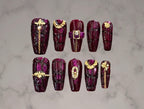 Luxury aubergine purple crocodile texture press-on nails with gold chains, buckles, clasps, and dimensional hardware