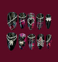 Luxury black and cerise tartan press-on nails with black lace, silver chains, pearls, bows, hearts, and punk-inspired jewelry accents