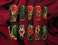 Luxury emerald green snakeskin and leopard print press-on nails with red roses, gold chains, heart-shaped gemstones, and jeweled accents.