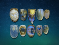 Luxury press-on nails featuring sculpted moonstone and glassy cat-eye with gold accents in celestial theme