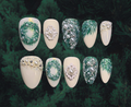 Luxury press-on nails featuring frosted pine leaves and pearl garland embellishments 