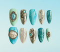 Luxury press-on nails of hyperrealistic crystal design featuring aquamarine, turquoise, freshwater pearl with silver chrome accents 