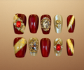 Luxury press-on nails with Renaissance inspired nail art with ruby and gold accents