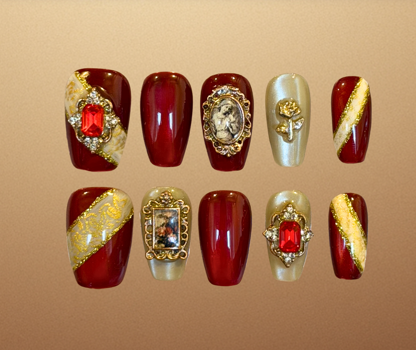 Luxury press-on nails with Renaissance inspired nail art with ruby and gold accents